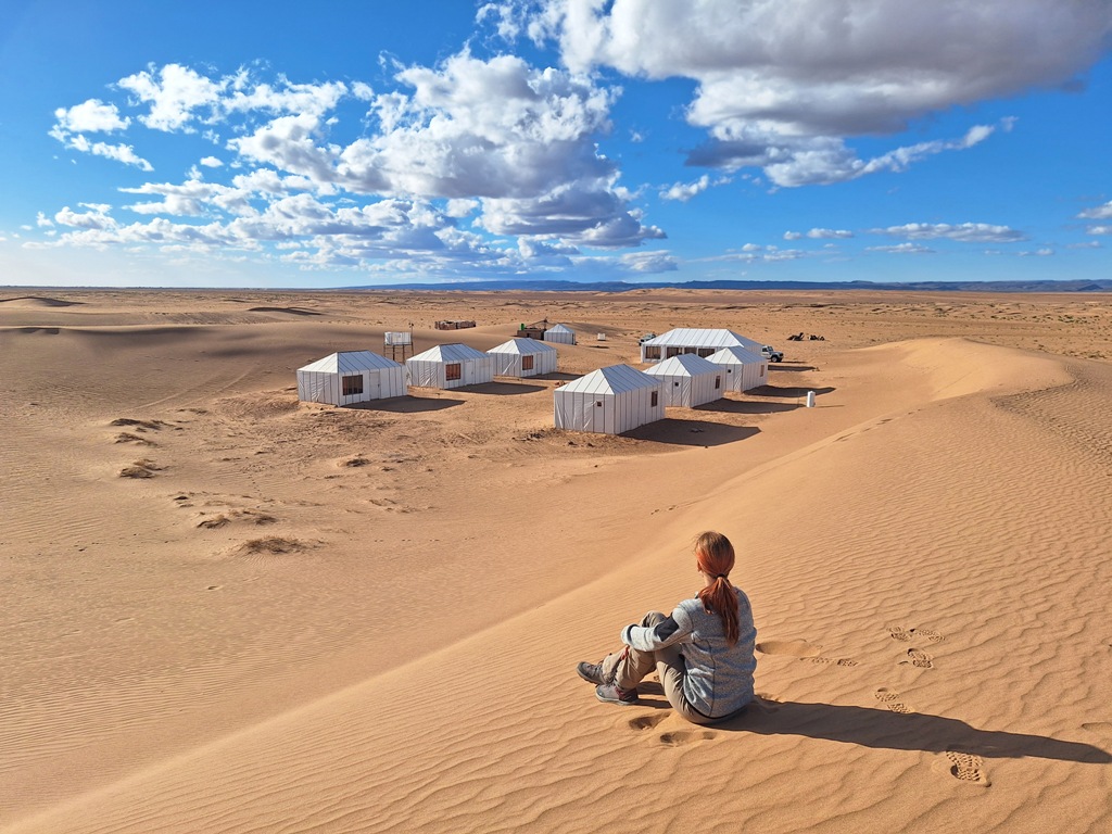 Woman looking at a traditional amazigh berber camp in Sahara