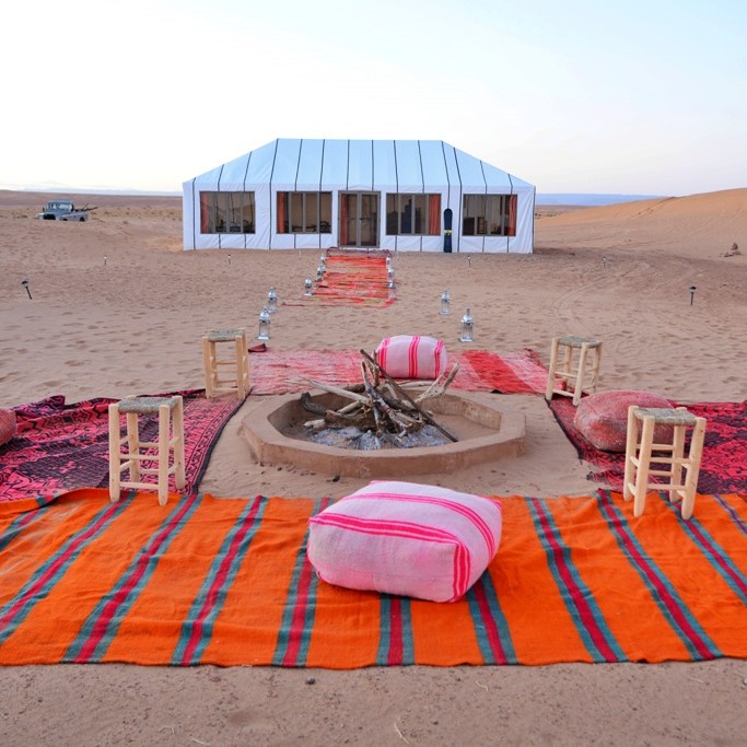 Fire pit and tent in Sahara desert