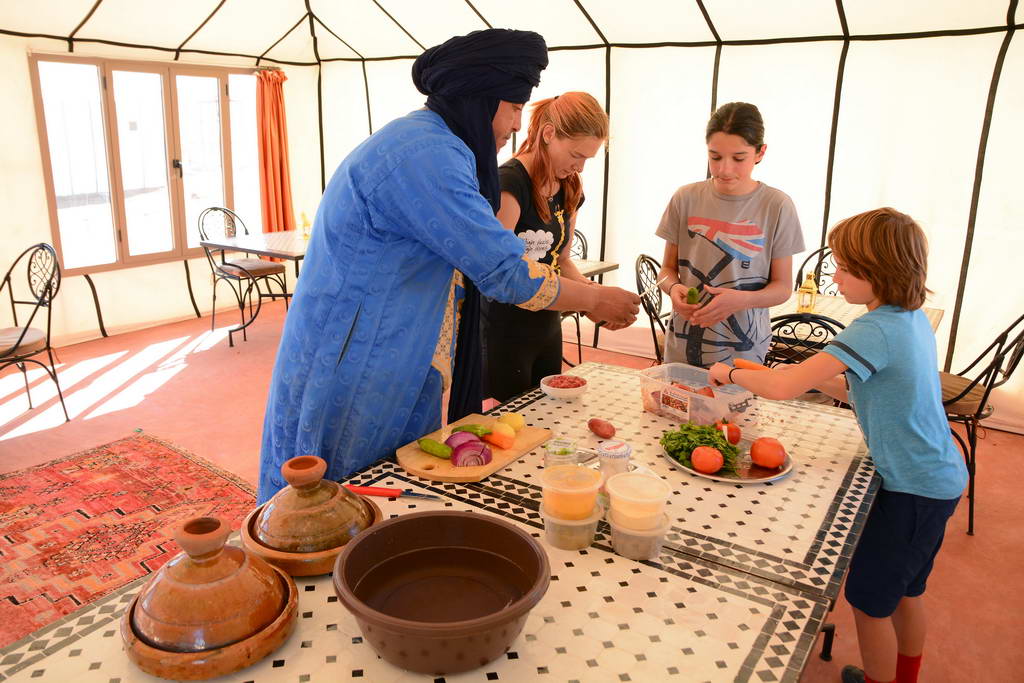 family cooking traditional tajine in Morocco